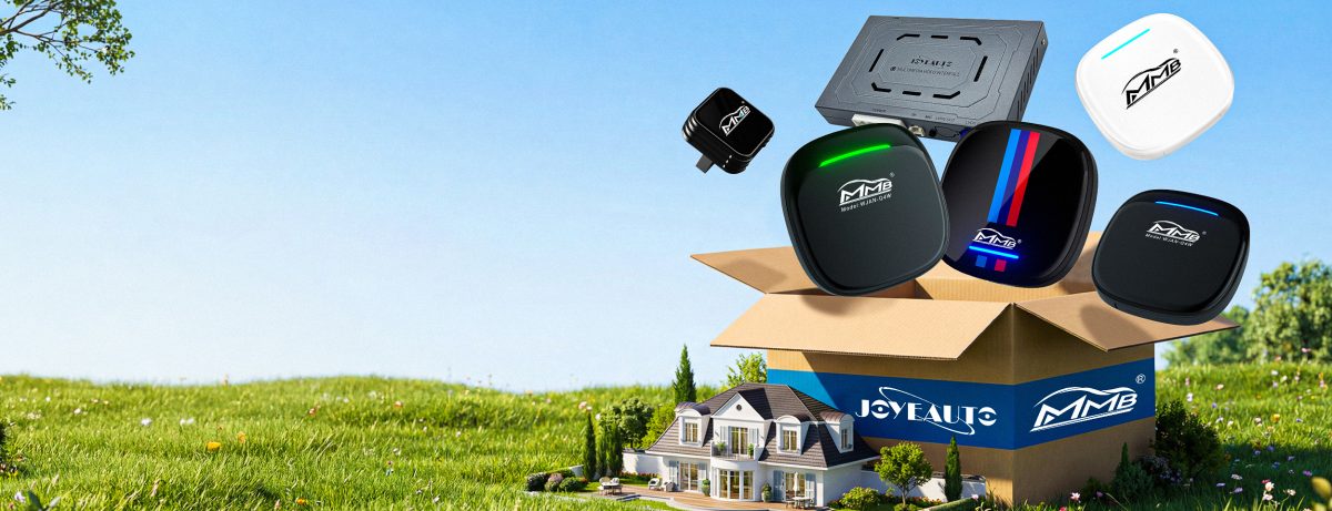 A promotional image featuring a box on a green field containing a variety of Joyeauto and MMB brand Wireless CarPlay Interface adapters and multimedia video boxes. The box is decorated with a miniature house, and MMB and Joyeauto logos are displayed prominently. Multiple devices, including some with green and M-color stripes, are shown.